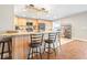 This bright kitchen features light wood cabinetry, a breakfast bar, and modern stainless steel appliances at 124 Pangola Dr, Winter Haven, FL 33880