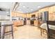 Updated kitchen with stainless steel appliances, light wooden cabinets, and a breakfast bar with granite countertops at 124 Pangola Dr, Winter Haven, FL 33880