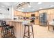 Bright and spacious kitchen featuring stainless steel appliances, a breakfast bar and light wood cabinetry at 124 Pangola Dr, Winter Haven, FL 33880
