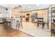 Open kitchen design with a breakfast bar, stainless steel appliances, and light wood cabinets at 124 Pangola Dr, Winter Haven, FL 33880