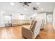 Open living room features wood floors, lots of recessed lighting, and comfortable seating at 124 Pangola Dr, Winter Haven, FL 33880