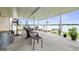 Covered patio with ample seating area featuring views of the lake at 124 Pangola Dr, Winter Haven, FL 33880