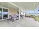 Covered patio with ample seating area featuring views of the lake at 124 Pangola Dr, Winter Haven, FL 33880