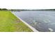Scenic waterfront featuring clear waters with lily pads and a concrete embankment at 124 Pangola Dr, Winter Haven, FL 33880