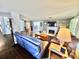 Spacious living room with hardwood floors, a brick fireplace, and modern furniture at 4145 Willis Rd, Mulberry, FL 33860