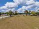 Expansive lot with lush grass, palm trees, blue sky, and puffy white clouds offering endless possibilities at 4145 Willis Rd, Mulberry, FL 33860