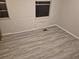 Bright bedroom with linoleum flooring; two windows bring light into the room, walls are lightly textured at 12828 Sw 49Th Ter, Webster, FL 33597