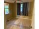 A cozy bedroom featuring large windows and tile flooring at 12828 Sw 49Th Ter, Webster, FL 33597