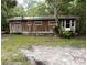 Charming exterior view of home, showcasing the windows and front yard at 12828 Sw 49Th Ter, Webster, FL 33597