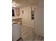 Functional kitchen space with white appliances, light wood cabinets, and linoleum flooring at 12828 Sw 49Th Ter, Webster, FL 33597