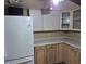 Charming kitchen featuring bright cabinetry and a modern refrigerator at 12828 Sw 49Th Ter, Webster, FL 33597
