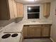 Bright kitchen features natural wood cabinets, modern countertops, and a sink with a window view at 12828 Sw 49Th Ter, Webster, FL 33597