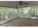 A covered porch area with screening offers outdoor living with views of the surrounding woods at 12828 Sw 49Th Ter, Webster, FL 33597