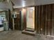 An unfinished room showing the wooden wall, tile floors and the door opening to the outside at 12828 Sw 49Th Ter, Webster, FL 33597