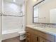 Bathroom featuring a tub with tiled wall, a vanity, and wood-look tile flooring at 19041 Mardi Gras St, Orlando, FL 32833