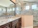 Elegant bathroom showcasing granite countertop vanity and modern, glass-enclosed shower with tile surround at 19041 Mardi Gras St, Orlando, FL 32833