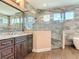 Chic bathroom with a large vanity, glass shower, decorative tile, and an abundance of natural light at 19041 Mardi Gras St, Orlando, FL 32833
