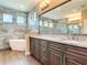 Stunning bathroom featuring a soaking tub, double vanity, granite countertops, and a spacious glass-enclosed shower at 19041 Mardi Gras St, Orlando, FL 32833