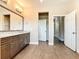 Elegant bathroom boasts a double vanity with granite countertops, wood-look tile flooring, and neutral walls at 19041 Mardi Gras St, Orlando, FL 32833