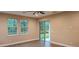 Comfortable bedroom with wood-look flooring, windows, and sliding doors at 19041 Mardi Gras St, Orlando, FL 32833