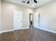 Spacious bedroom featuring wood-look tile floors and ample closet space at 19041 Mardi Gras St, Orlando, FL 32833