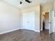 Bedroom with closet and attached bathroom, featuring wood-look tile flooring at 19041 Mardi Gras St, Orlando, FL 32833