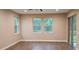 Bright bedroom with natural light, wood-look flooring, and sliding glass doors at 19041 Mardi Gras St, Orlando, FL 32833
