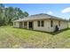 Well-maintained backyard featuring a manicured lawn, patio, and neutral-colored exterior at 19041 Mardi Gras St, Orlando, FL 32833
