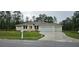 Charming single-story home featuring a three-car garage and neutral color palette, complemented by a well-manicured lawn at 19041 Mardi Gras St, Orlando, FL 32833