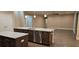 Open kitchen features dark wood cabinets, granite countertops, stainless appliances, and a center island at 19041 Mardi Gras St, Orlando, FL 32833