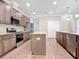 Modern kitchen featuring stainless steel appliances, granite countertops, a functional island, custom cabinets and wood floors at 19041 Mardi Gras St, Orlando, FL 32833
