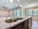 Close up view of the kitchen featuring granite countertops, stainless steel appliances, an island, and wood floors at 19041 Mardi Gras St, Orlando, FL 32833