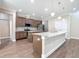 Gourmet kitchen with granite countertops, double islands, stainless steel appliances, custom cabinetry, and wood floors at 19041 Mardi Gras St, Orlando, FL 32833
