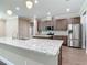 Spacious kitchen featuring granite countertops, an island with a sink, stainless steel appliances, and wood flooring at 19041 Mardi Gras St, Orlando, FL 32833