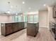 Spacious open-concept kitchen with dark wood cabinets, granite countertops, and wood-look tile flooring at 19041 Mardi Gras St, Orlando, FL 32833