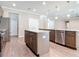 Eat in kitchen featuring wood floors, a stainless steel dishwasher, granite countertops, and a large island with a sink at 19041 Mardi Gras St, Orlando, FL 32833