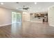 Open concept living room and kitchen with wood floors, recessed lighting, ceiling fan, and stainless steel appliances at 19041 Mardi Gras St, Orlando, FL 32833