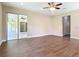 Spacious living area featuring wood-look floors, recessed lighting, and sliding glass doors to outdoor space at 19041 Mardi Gras St, Orlando, FL 32833