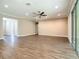 Large living room with hard wood floors, recessed lights, ceiling fan and sliding glass doors at 19041 Mardi Gras St, Orlando, FL 32833