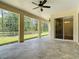 Large covered patio with ceiling fans and serene views of the wooded backyard at 19041 Mardi Gras St, Orlando, FL 32833