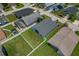 An aerial shot of the home's backyard featuring a green lawn and neighboring houses at 2576 Boots Rd, Lakeland, FL 33810