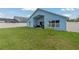 Expansive fenced backyard with a covered patio and ample lawn space at 2576 Boots Rd, Lakeland, FL 33810