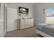 Bright bedroom with neutral colors, a mounted television, and a comfortable bed at 2576 Boots Rd, Lakeland, FL 33810