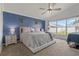 Primary bedroom featuring dark blue accent wall, a window for natural light, and a comfortable bed at 2576 Boots Rd, Lakeland, FL 33810