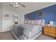 Primary bedroom featuring dark blue accent wall, a window for natural light, and a comfortable bed at 2576 Boots Rd, Lakeland, FL 33810