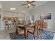 Dining room with modern light fixture, blue rug, and a wood table that seats eight people at 2576 Boots Rd, Lakeland, FL 33810