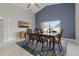 Bright dining room with a mounted television, blue rug, and a wood table that seats eight people at 2576 Boots Rd, Lakeland, FL 33810