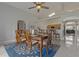 Bright dining room with a ceiling fan, blue rug, and a wood table that seats eight people at 2576 Boots Rd, Lakeland, FL 33810