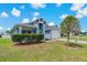 Charming single-story home with light blue exterior, two car garage and manicured lawn at 2576 Boots Rd, Lakeland, FL 33810