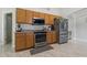 A well-lit kitchen features stainless steel appliances, ample cabinetry and modern tiled floor at 2576 Boots Rd, Lakeland, FL 33810